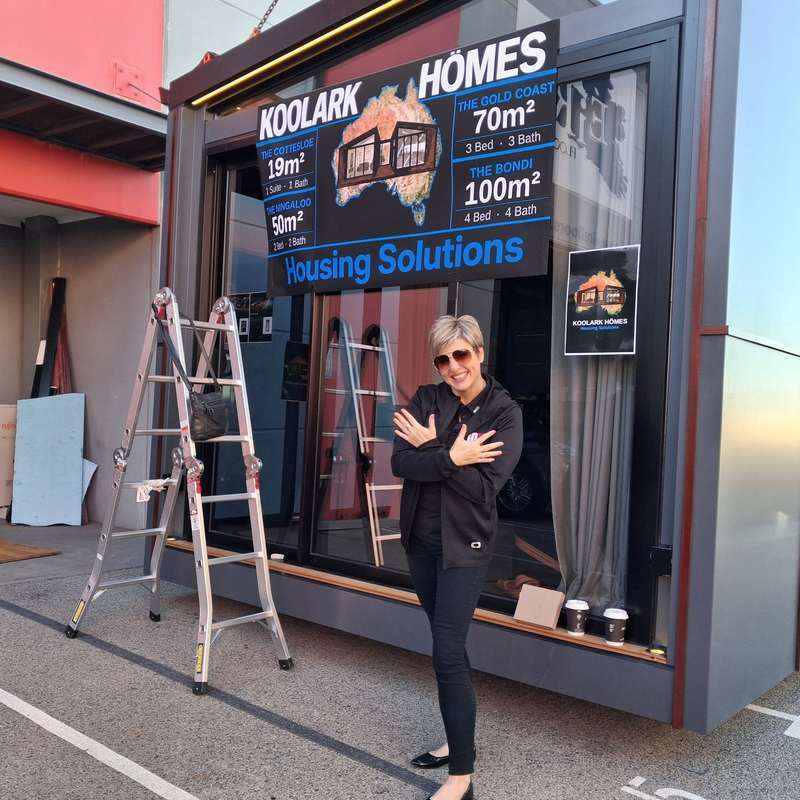 Marissa from the Grant Cardone 10X Network in front of the KOOLARK HOMES Housing Solutions display at Homebase