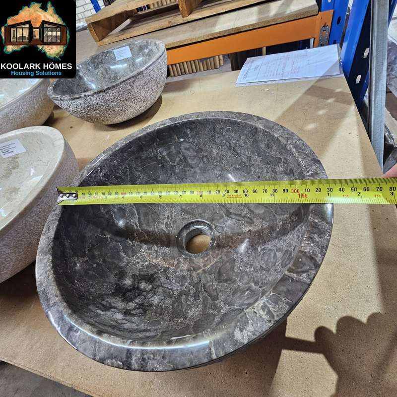 KOOLARK HOMES dark natural stone basin sample measured with a tape measure beside other basin finishes