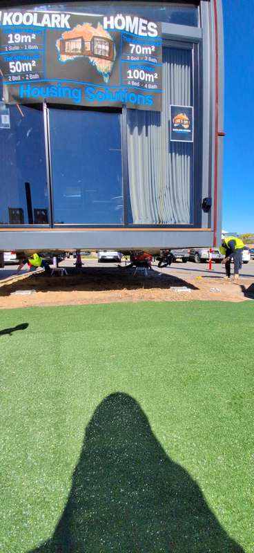 KOOLARK HOMES display module being positioned above prepared footing points at Homebase