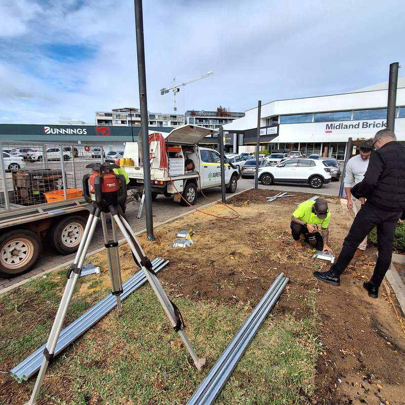 KOOLARK HOMES site team using a survey tripod and positioning footing components