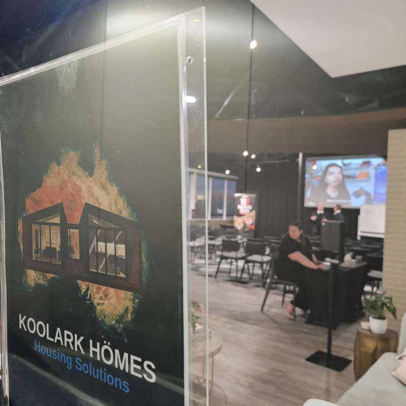 KOOLARK HOMES Housing Solutions branding at a Homebase event space