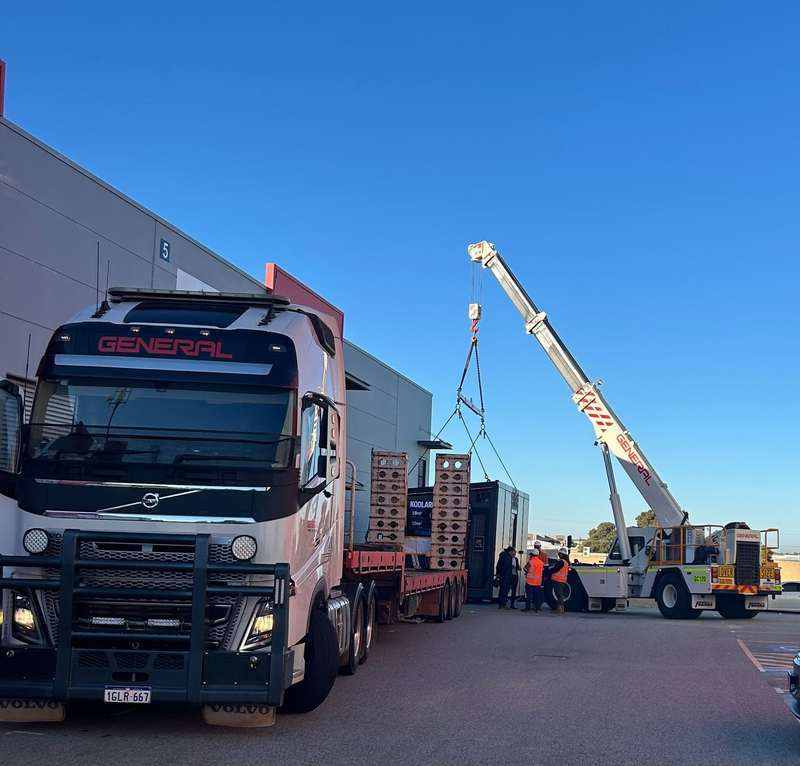 KOOLARK HOMES modular home display module being handled by crane and transport equipment