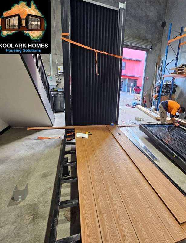 KOOLARK HOMES modular home factory-floor installation with flooring and worker