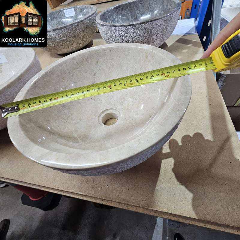 KOOLARK HOMES natural stone basin sample measured with a tape measure beside additional stone basins
