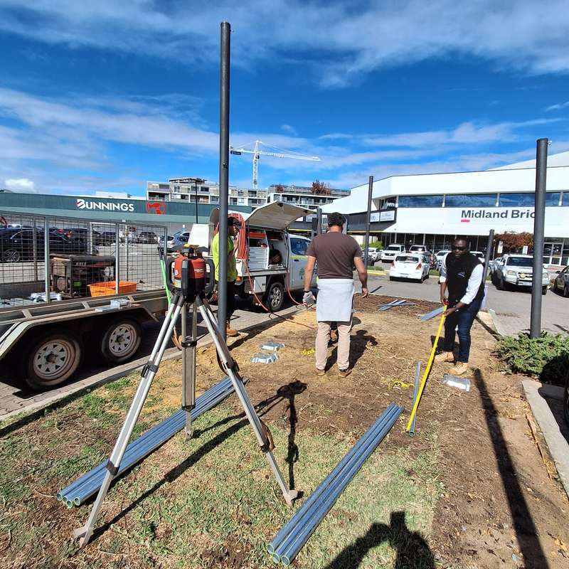 KOOLARK HOMES site crew setting out footing positions with survey equipment and measurement tools